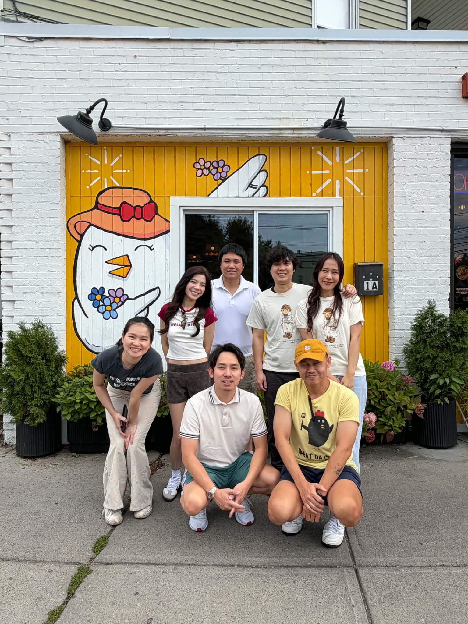 What Da Chick team together outside the restaurant mural